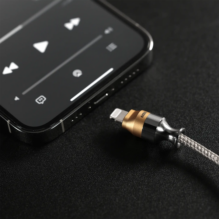 ddHiFi M110A cable lightning next to iPhone sitting on black table