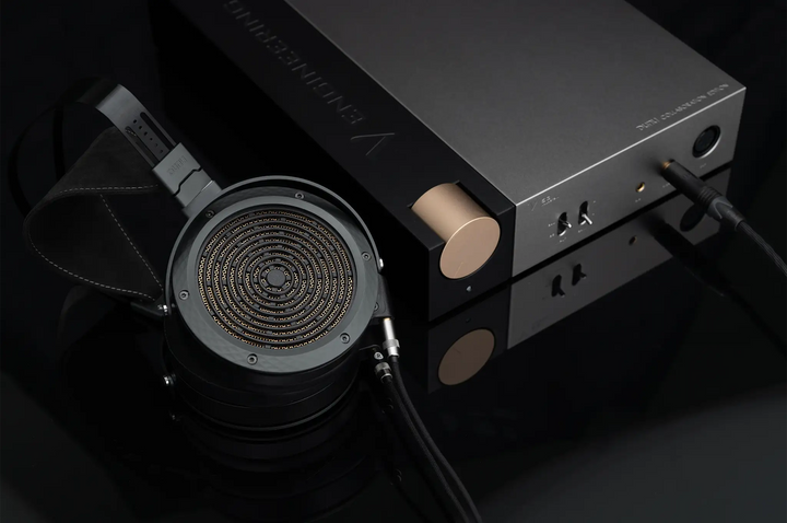 DUNU V53 headphone amplifier with Arashi headphone plugged in sitting on black background