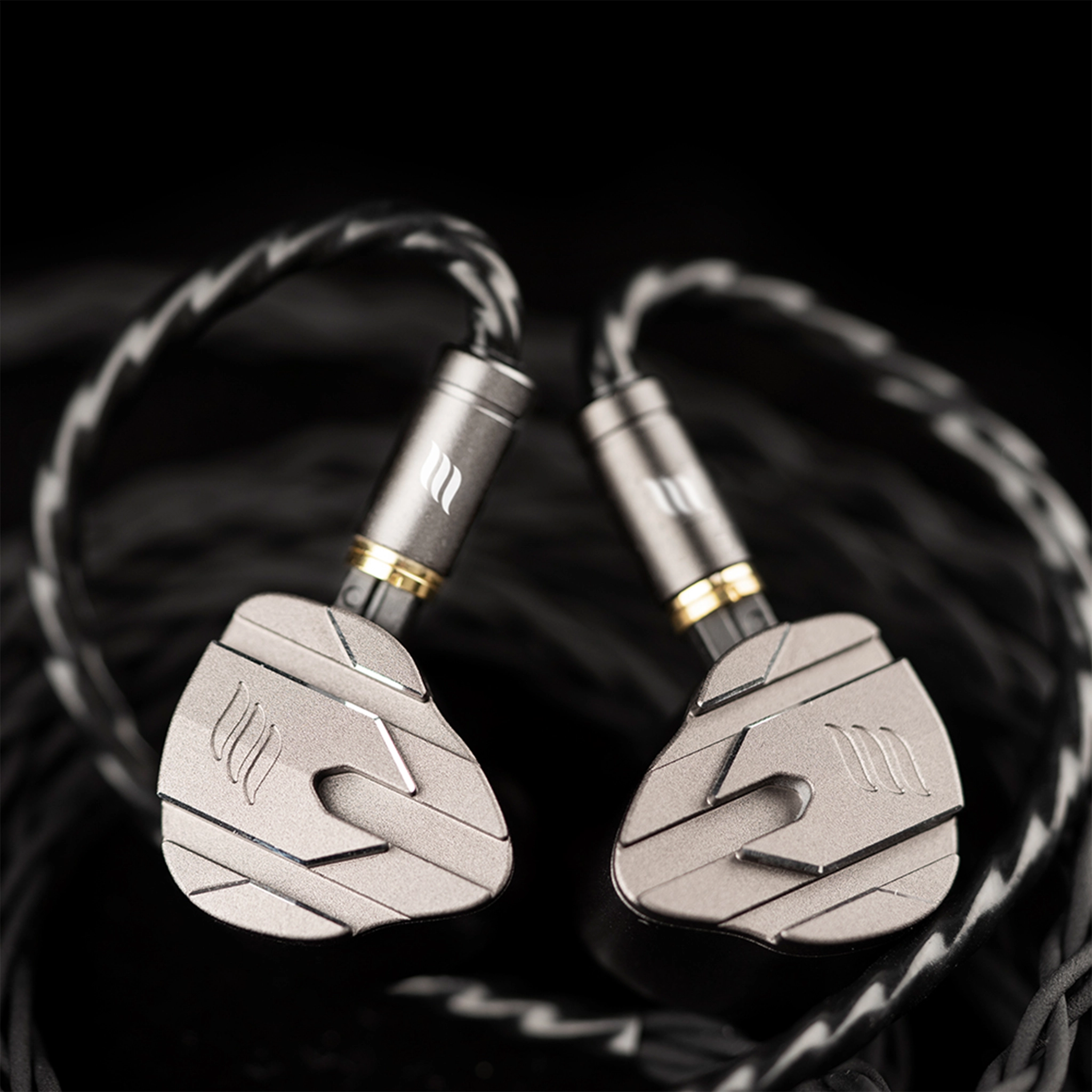 Pair of effect audio perseus iems with metallic finish on a dark background
