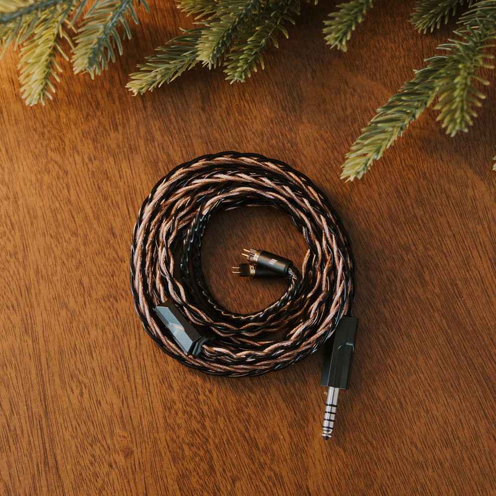 Effect Audio Christmas 2025 cable coiled with christmas tree on wooden table Birdseye view