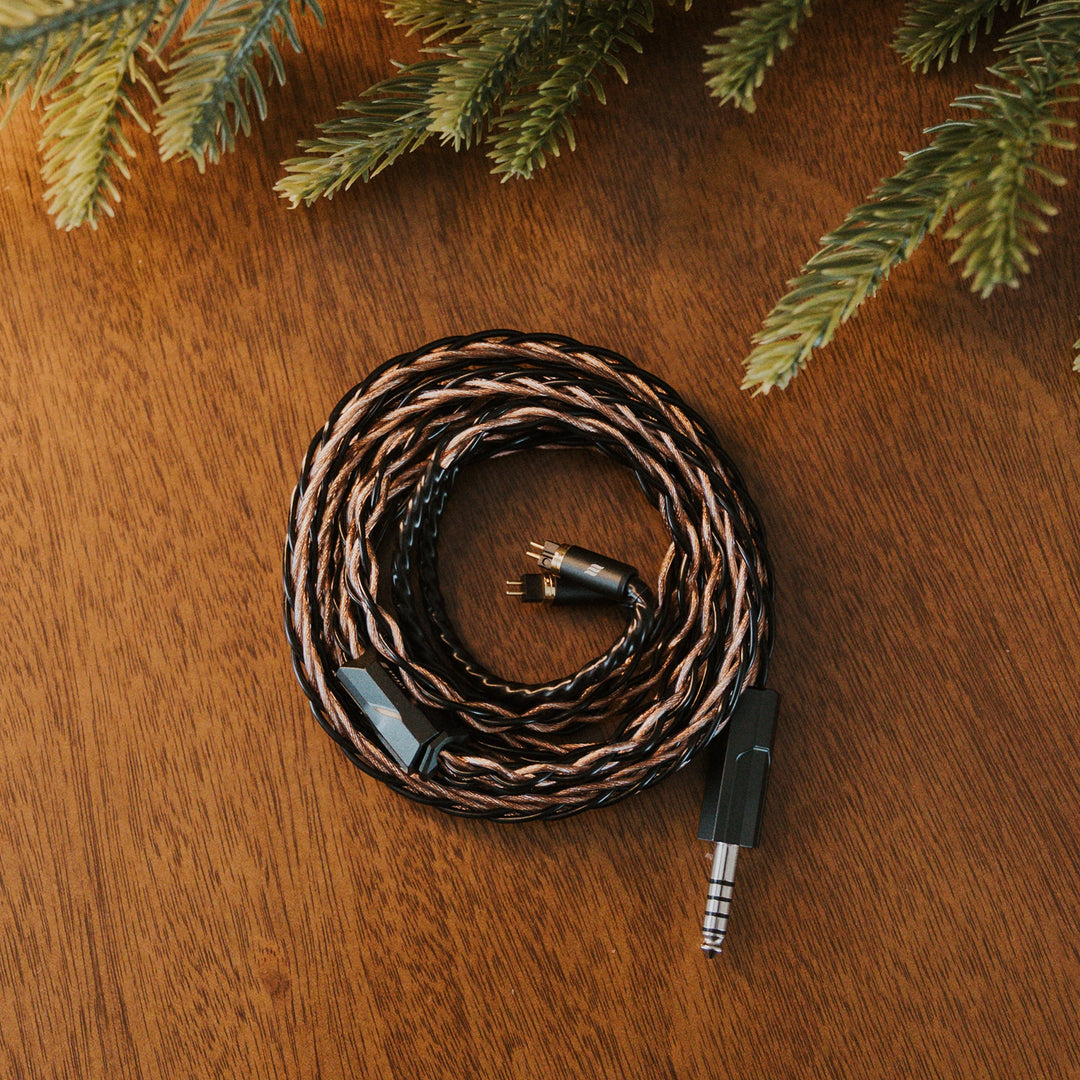 Effect Audio Christmas 2025 cable coiled with christmas tree on wooden table Birdseye view