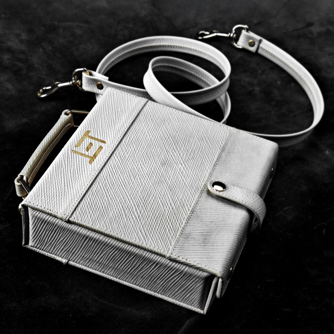 Eletech Canvas Companion Case lying on black background with bag strap beside it