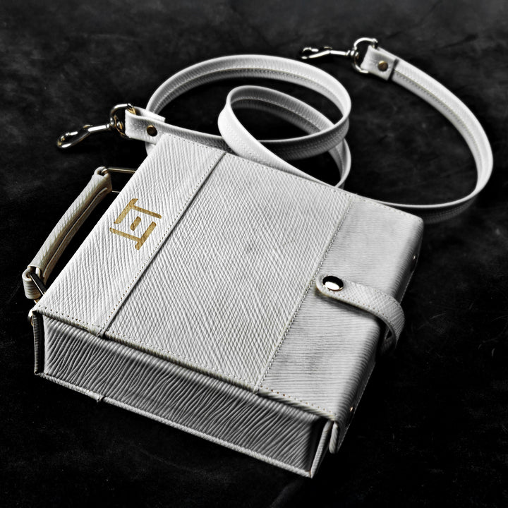 Eletech Canvas Companion Case lying on black background with bag strap beside it