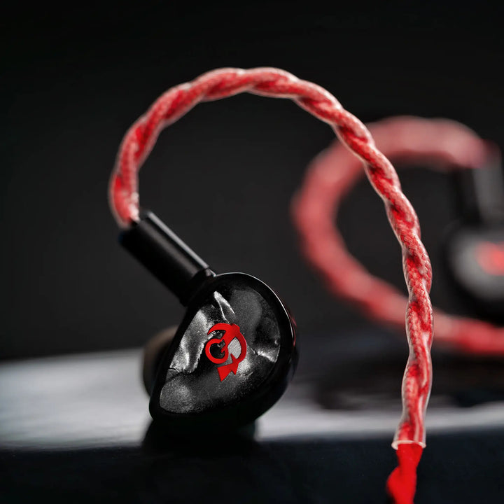 FATfreq x HBB Deuce closeup left earphone with attached blood cable Bokeh black background