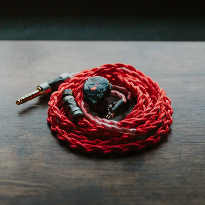 FATfreq x HBB Deuce closeup high angle with attached coiled stock red blood cable on wood table