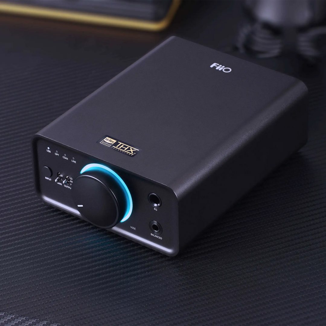 FiiO K7 DAC/Amp front right 3 quarter angle sitting on black desk