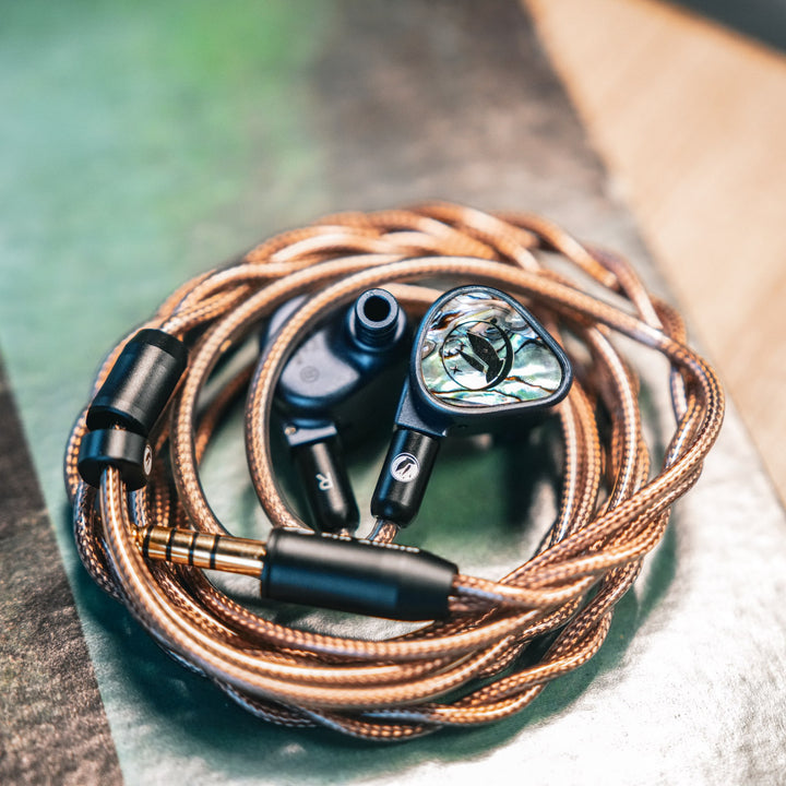 FiR Audio Electron 12 with attached coiled copper cable over vinyl sleeve