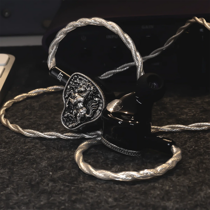 FlipEars Arion IEMs front and top view sitting on grey desk with amp in background