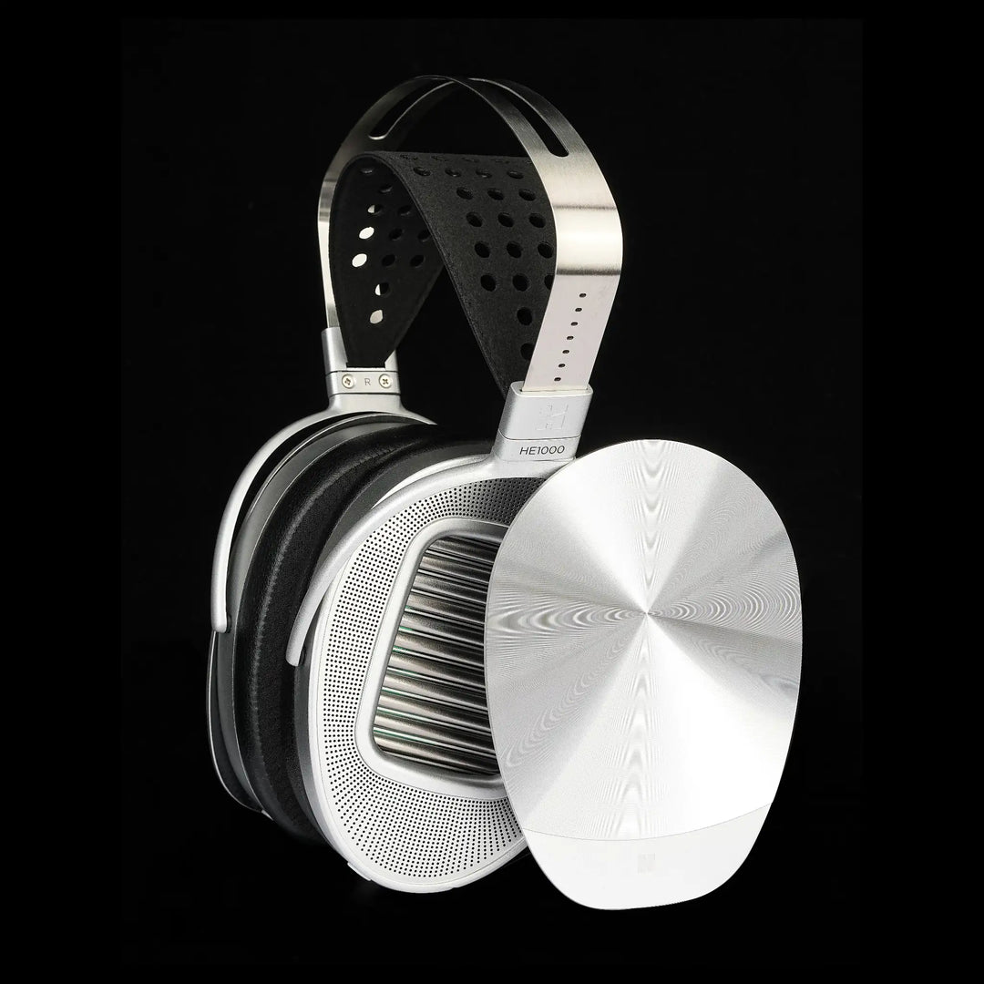 HIFIMAN HE1000 Unveiled profile with removed veil leaning on earcup over black background