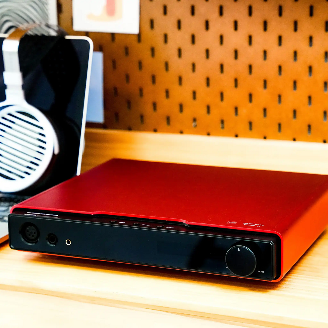 HIFIMAN Serenade Jr DAC amp sitting on wooden desk with Susvara unveiled headphones front right 3 quarter angle