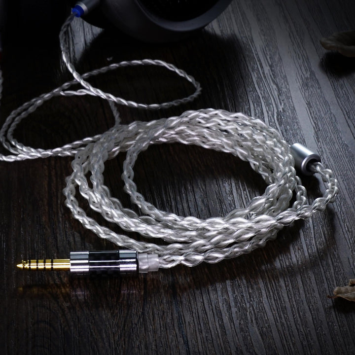 iBasso CB17 silver cable coiled over dark wood table