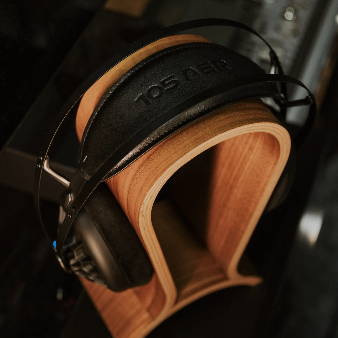 Meze 105 AER on wood headphone stand high angle highlighting logo on headband