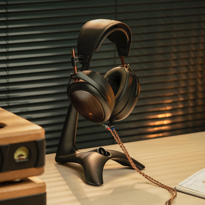 Meze Liric 2 front quarter on headphone stand with warm dramatic lighting