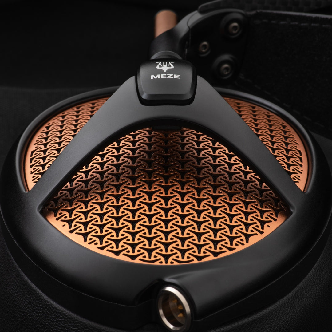 Meze Audio Empyrean black copper closeup earcup over black background