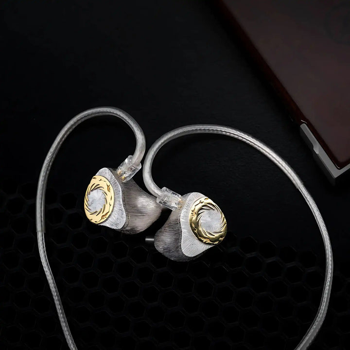 Moondrop Solis 2 IEMs sitting diagonally with PURE6 cable attached with DAP on black background