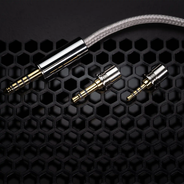 Moondrop Solis 2 cable and interchangeable termination plugs on black grate background