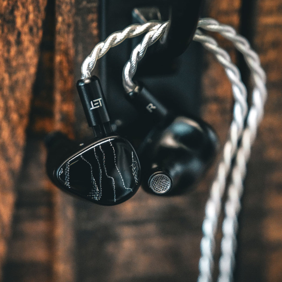 Noble Onyx closeup with attached stock cable hanging on hook over wood background