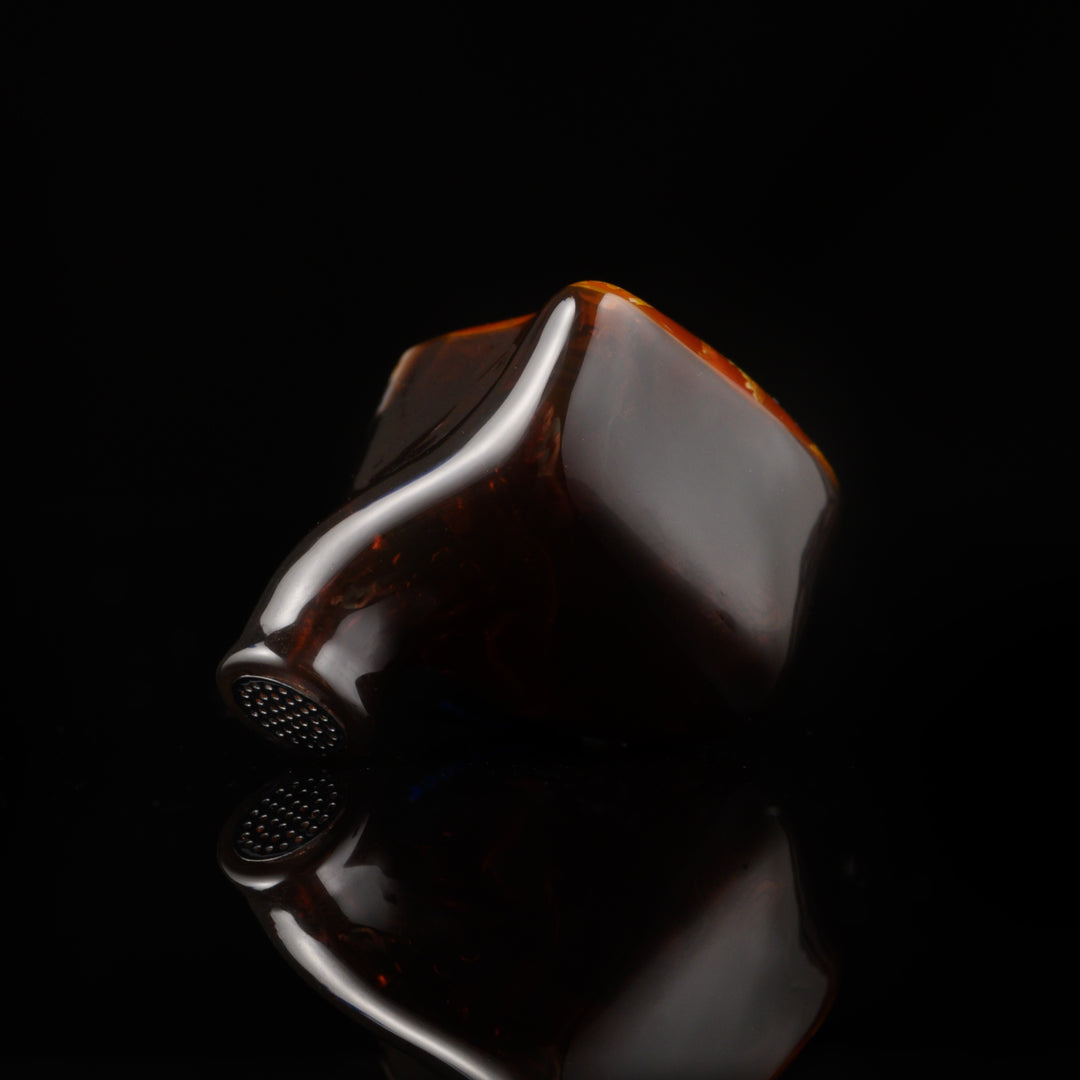 Noble Audio Spartacus single IEM rear closeup over black reflective background