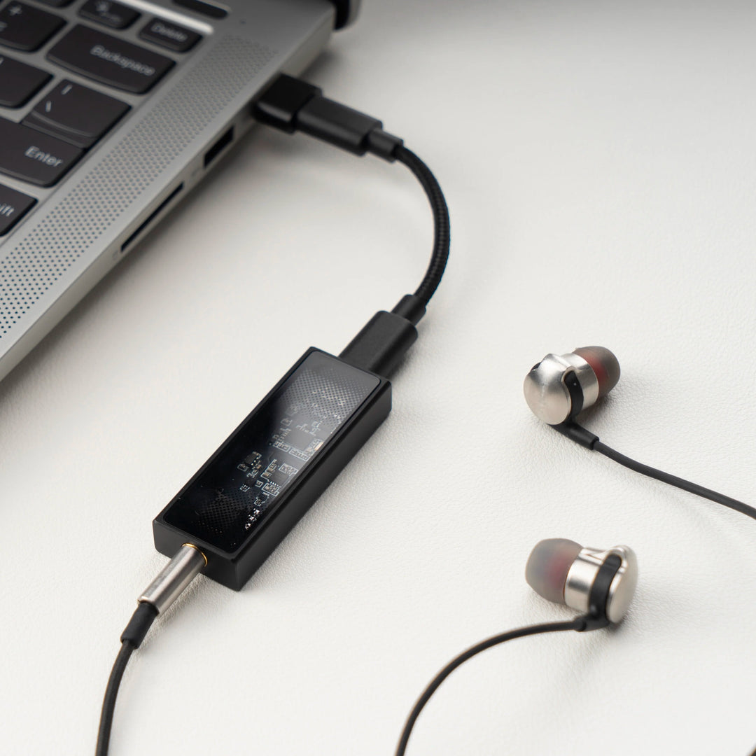 Questyle M12i with attached earbuds connected to Macbook