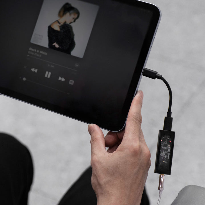 Questyle M12i with attached headphone cable connected to iPad