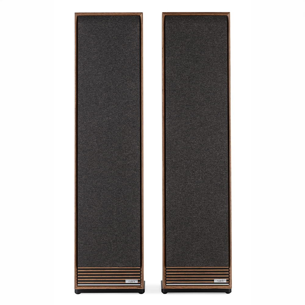 Ruark Audio Talisman R floorstanding speakers with dark gray fabric front panels and a warm brown wood-grain frame, shown side-by-side against a plain white background.