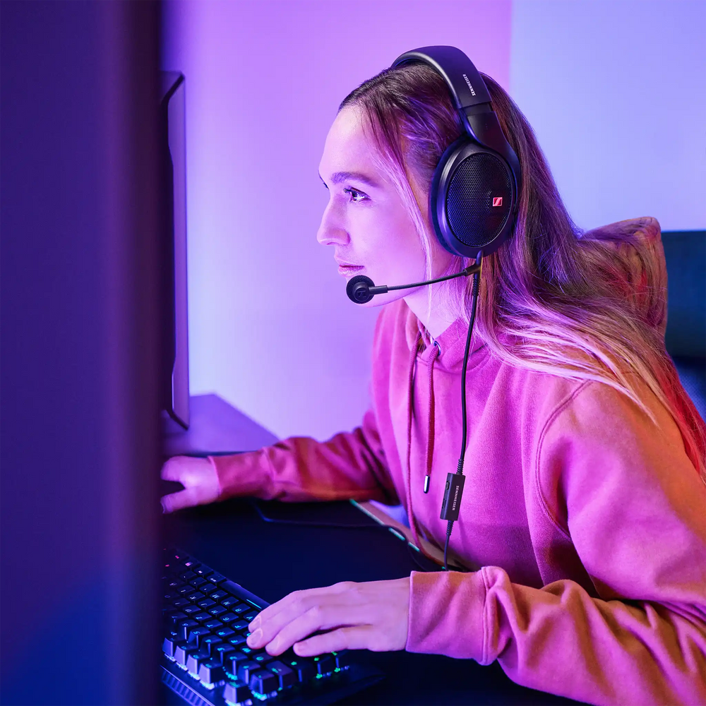 Sennheiser HD 500 BAM boom mic on woman using Sennheiser headphones playing desktop video games 