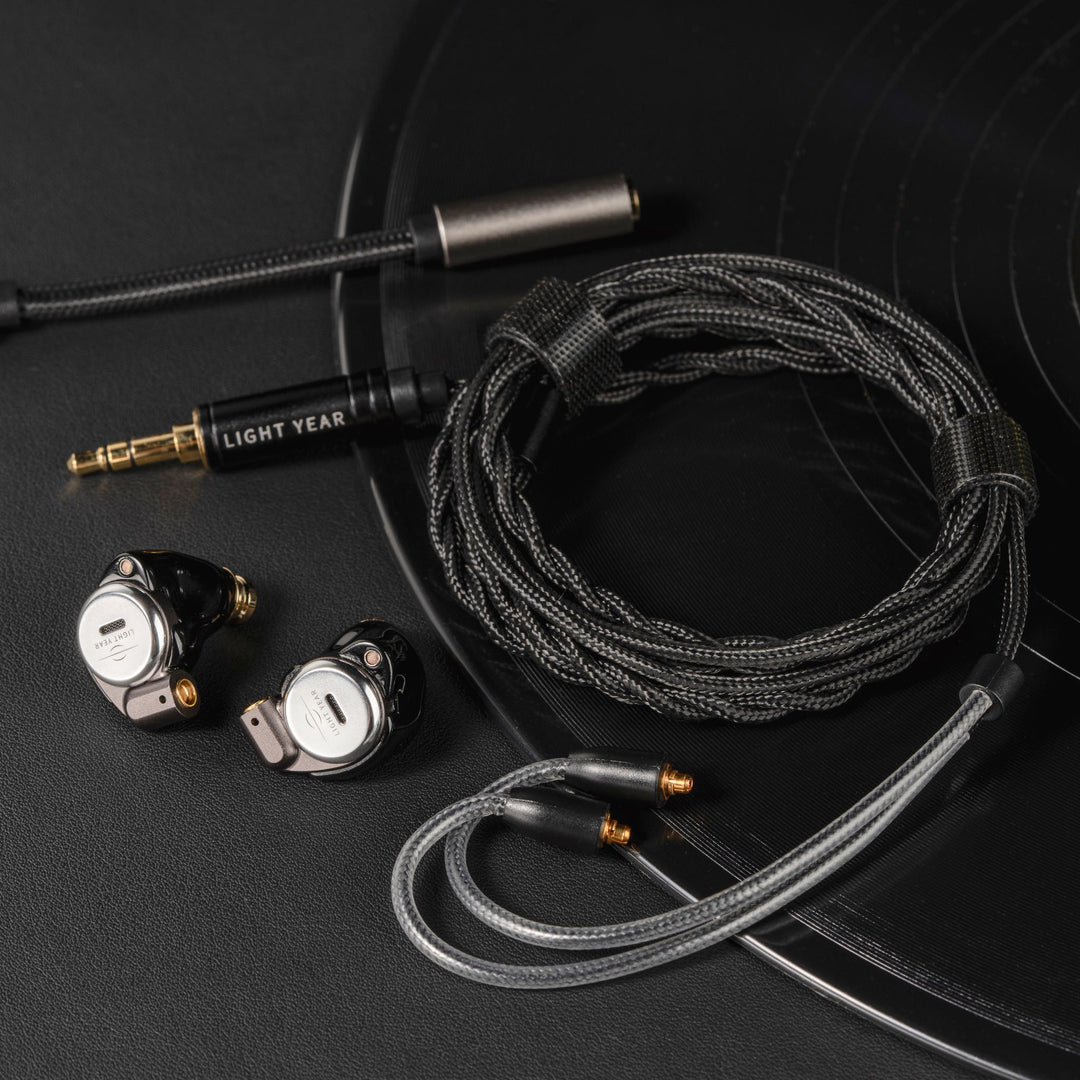 Star City 5 PRO IEMs with detached, coiled stock cable and DAC dongle over vinyl record