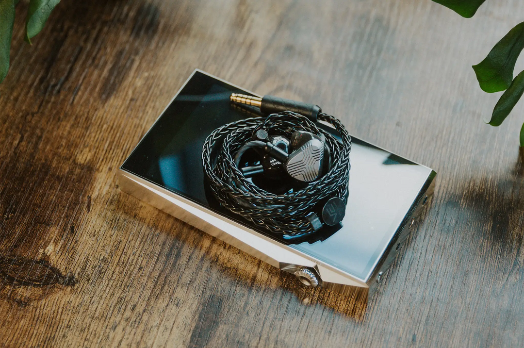 Vision Ears EXT MKII IEMs coiled in cable sitting on Astell&kern DAP on wooden table