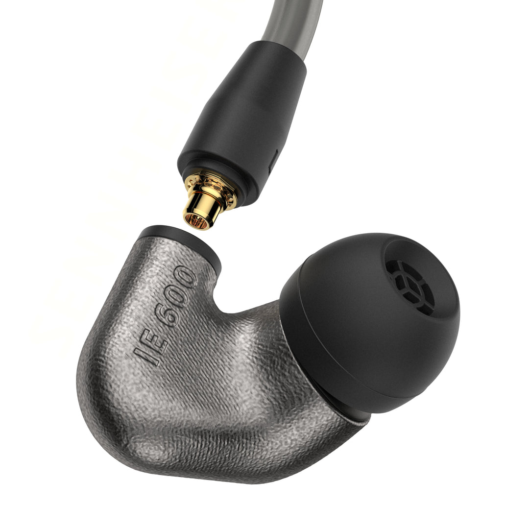 Sennheiser IE 600 shell with ear tip and disconnected cable over white background