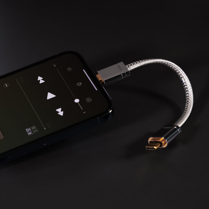 ddHiFi USB Lightning to USB-C cable connected to iPhone over dark background