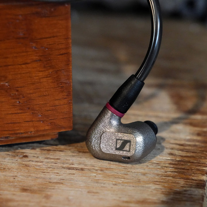 Sennheiser IE 600 earphones with cable on wood table from Bloom gallery