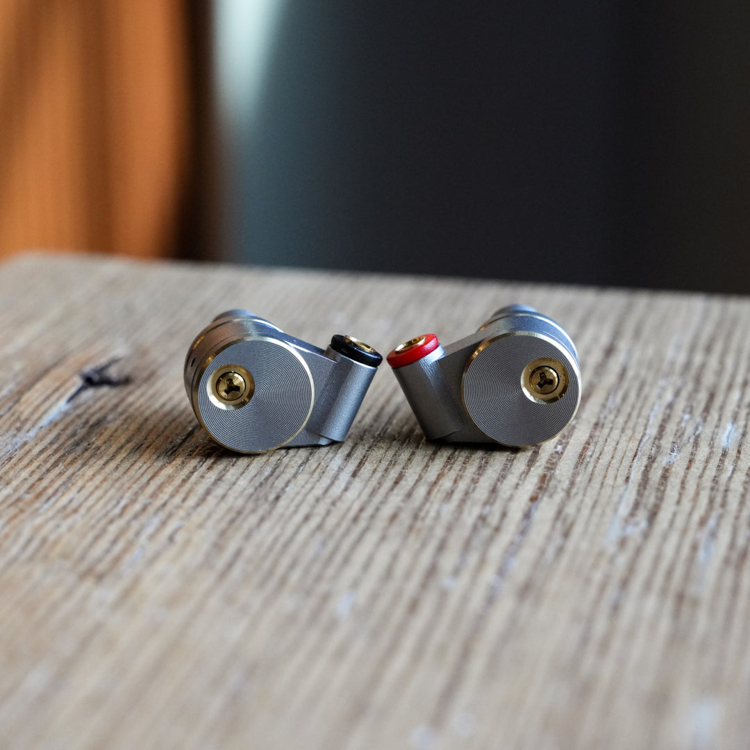 Ucotech RE-2 earphones without cable on wood shelf from Bloom Audio gallery